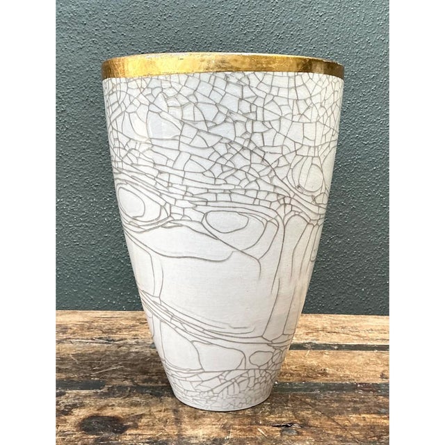 This vintage Italian ceramic vase showcases a striking tapered silhouette, its broad, cone-shaped body narrowing...