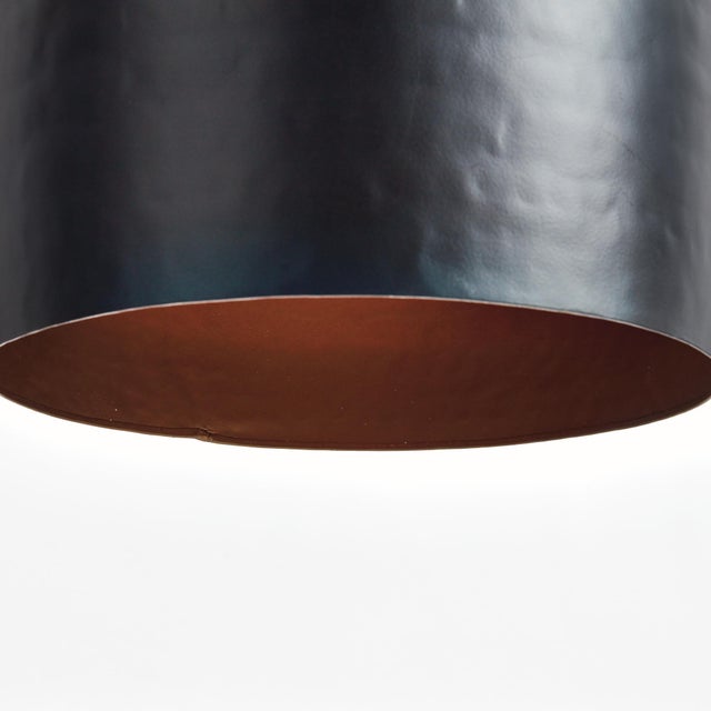 Simple in form but scaled to impress, this matte black pendant is a real beauty. With a warmGold interior, a handsome...