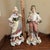 Beautiful antique German porcelain figurines, featuring a young woman with a basket and a young man holding flowers. Both...