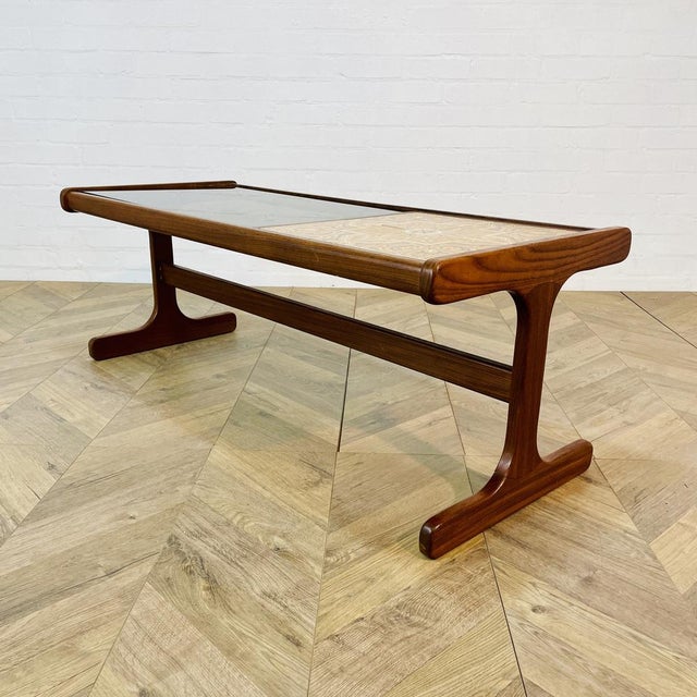 An iconic Mid-Century English Coffee Table from G-Plan, Circa 1960s. The table was made from teak, with ceramic tiles and...
