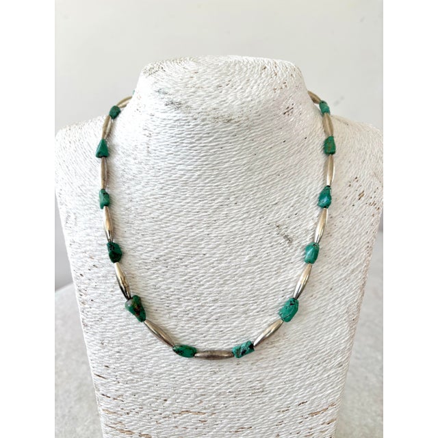 Handmade southwestern or Native American-style jewelry.It features irregularly shaped turquoise nuggets interspersed with...