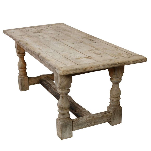 A French Farmhouse Table with turned legs, crafted from weathered oak for a rustic yet elegant look. Spacious and sturdy,...