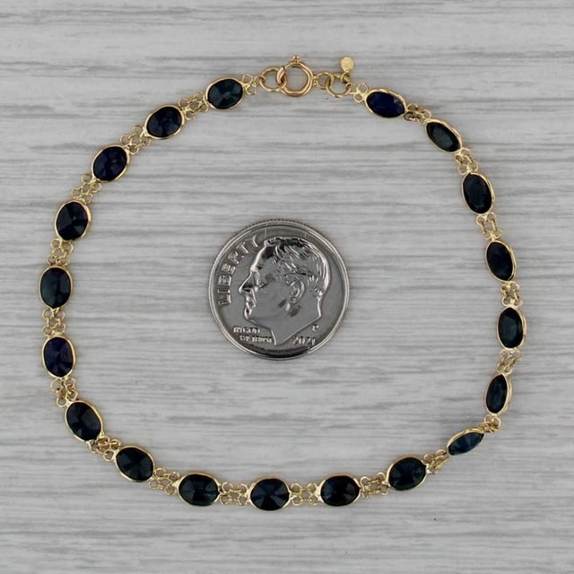 Gemstone Information: - Natural Sapphires - Total Carats - 6.60ctw Cut - Oval Color - Dark Blue Treatment - Heated Metal:...
