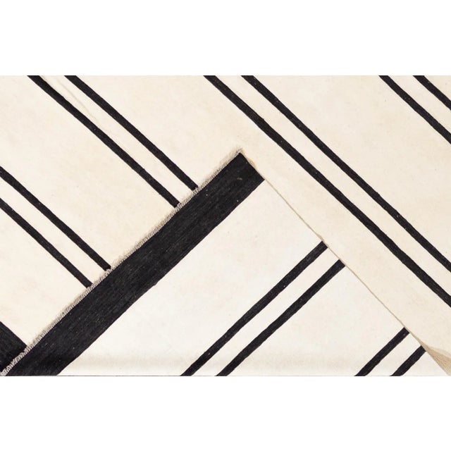 Beautiful 21st century contemporary Kilim rug, handwoven wool in an all-over black and white striped design. This rug...