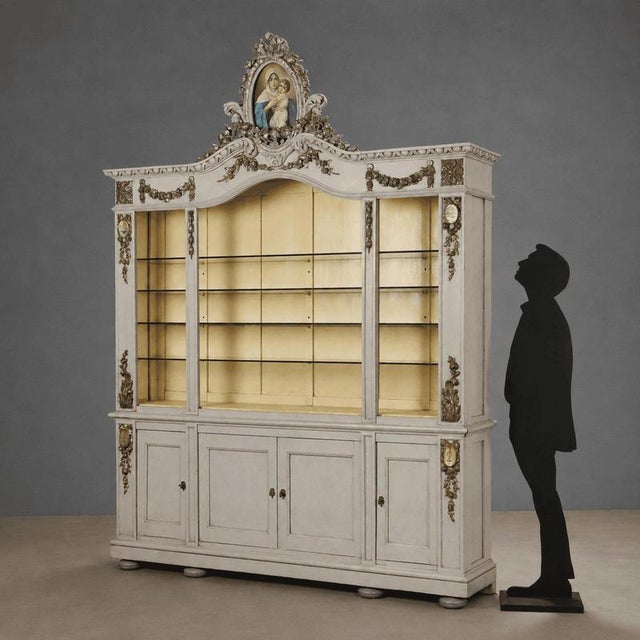 Two-part sideboard in lacquered fir with carved and silvered details, typical of mid-19th century Italy. The open top...