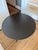 Industrial round blackened metal side table with tripod base. I’m not sure of the maker, as the item was purchased along...