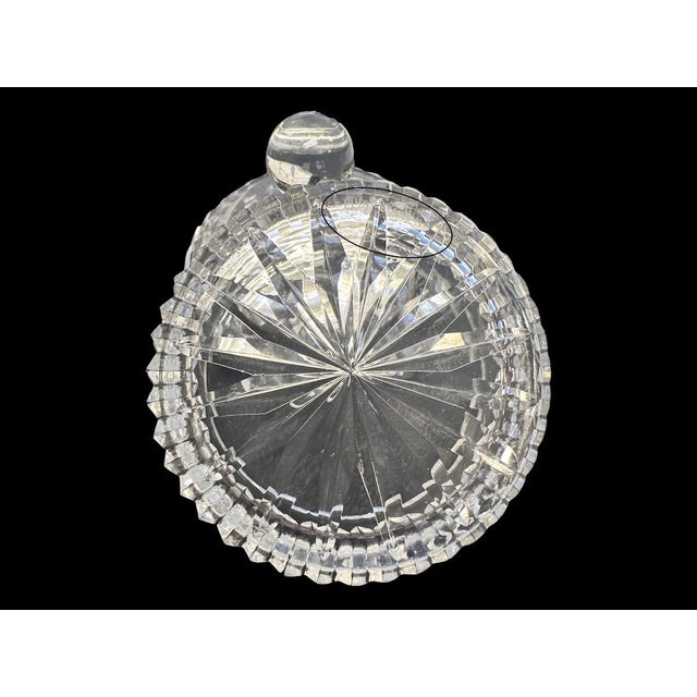 Elegant signed Waterford cut crystal jar with a domed lid and round finial. Features deep vertical and crisscross cuts...