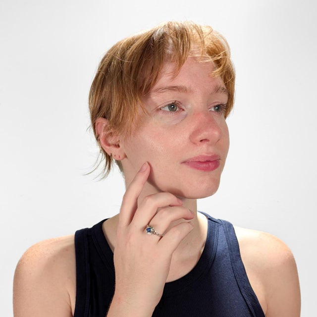 A fine Art Deco style ring. In 14 karat white gold. Bezel-set with a round star sapphire cabochon. In a high-set filigree...