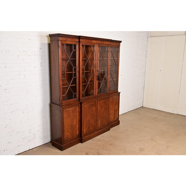 A gorgeous Georgian or Chippendale style breakfront bookcase or dining cabinet In the manner of Baker Furniture USA, Circa...