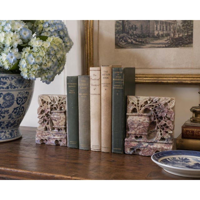 A charming pair of antique Chinese soapstone bookends dating to the 1920s, each intricately carved with flowering branches...