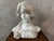 A superb sculpted marble bust depicting a young woman with delicate features, typical of the art nouveau aesthetic. Her...