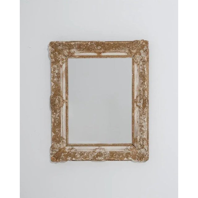 This antique French mirror offers an elegant 19th century design in giltwood. Made in the 1800s, carved rosettes adorn the...