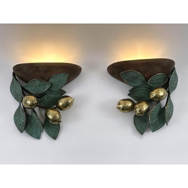 Set of two exceptional, elegant and highly decorative mid-century modern brass lemon sconces or wall fixtures. Designed &...