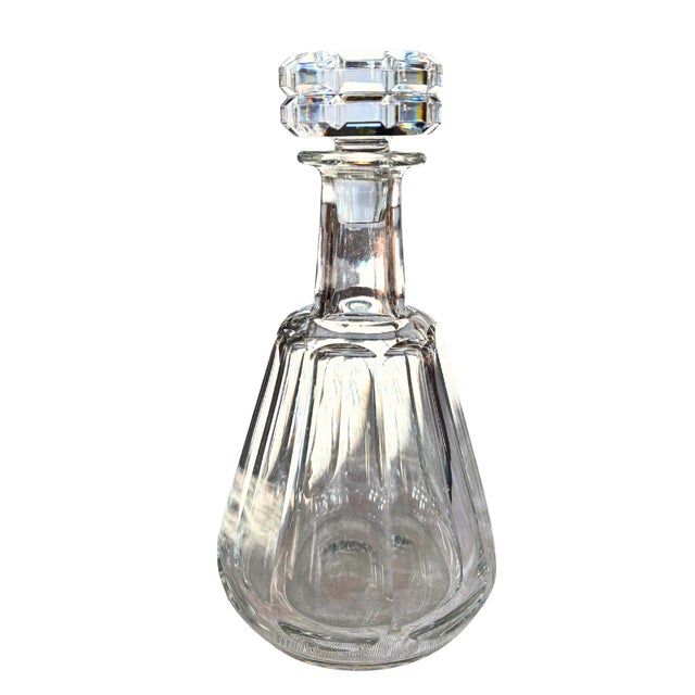 A striking baccarat crystal whisky set centered around an architectural talleyrand decanter, celebrated for its sculptural...