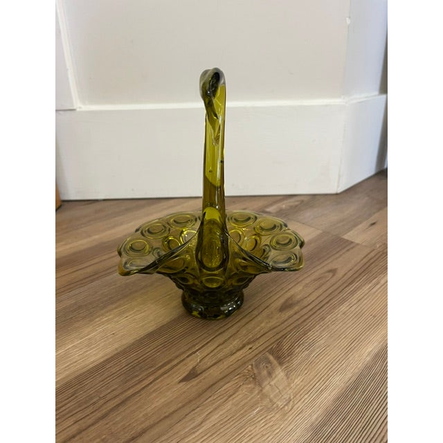 This is a vintage mid-century modern olive green art glass swan trinket dish featuring a textured circle pattern along the...