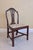 A graceful early 19th century Hepplewhite-style side chair featuring a classic shield-shaped back with an intricately...