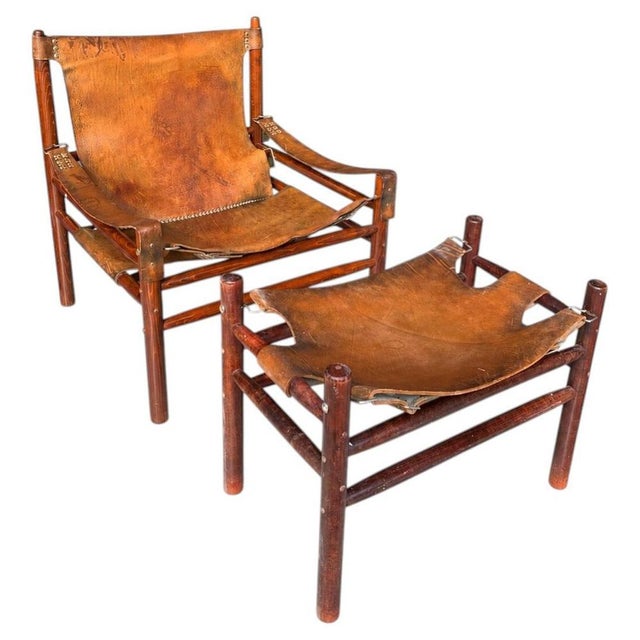 Safari chair with ottoman made of leather with a beautiful patina. Manufactured in the 1970s. Thanks to the solid wood and...