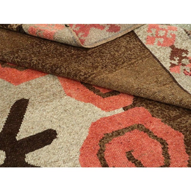 Mid 20th century turkish kars rug with a large-scale masculine design on a orangey red ground