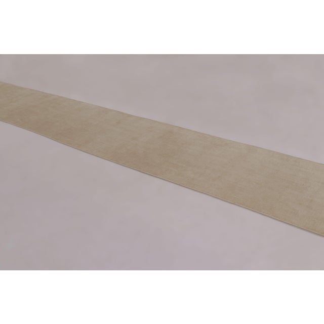 Made with a luxurious blend of silk, this 3x19 contemporary extra-long runner rug is a luminous masterclass in luxury,...