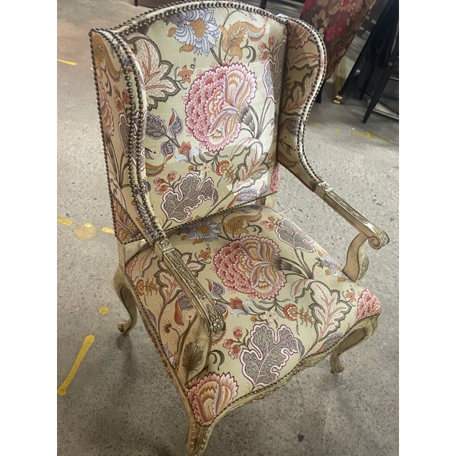 A beautifully handcrafted French Rococo wing chair, upholstered in a luxurious, high-end fabric with bold peony-style...