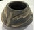 This hand-coiled Native American Santa Clara Pueblo, NM pottery vessel features a dark gunmetal finish with carved...