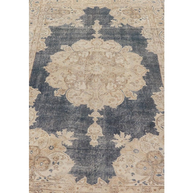 Measures: 5'2 x 8'5 Distressed Turkish Carpet with Floral Design in Blue, Tan, Taupe, and Cream. Keivan Woven Arts /...