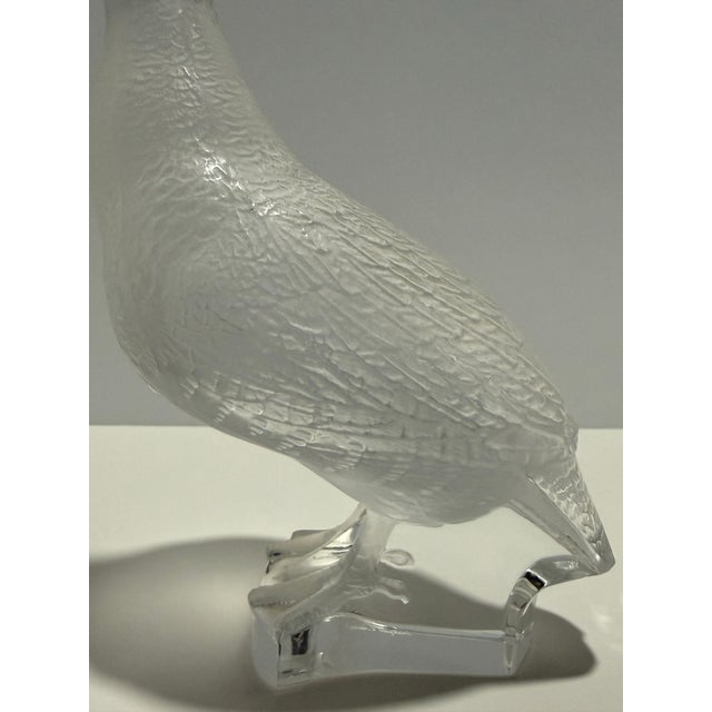 Elegant crystal sculpture depicting a quail or game bird, crafted by Lalique France in their signature frosted satin...