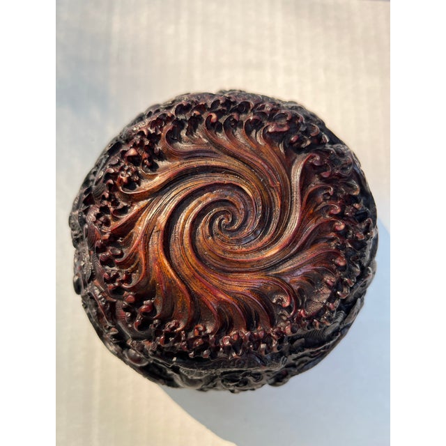 A single carved Chinese bowl featuring dragons, clouds, and symbols.