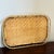 Offering a circa 1960 handcrafted bamboo & rattan tiki tray. This fun tray features a herringbone pattern rattan top,...