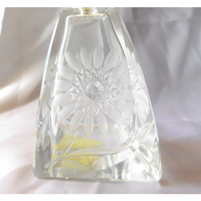 This is a clear glass perfume bottle. The vintage bottle is likely crystal, and the design is very unique. Every angle is...