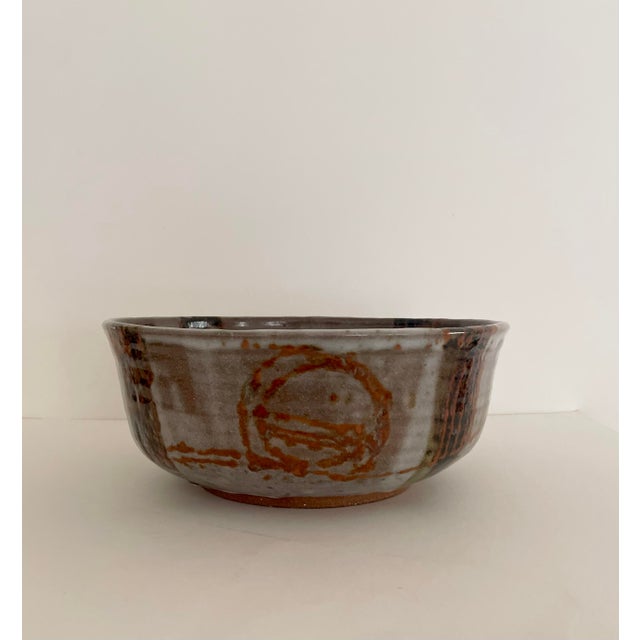 Beautiful large handcrafted ceramic bowl with abstract glazed design. Shades of burnt orange, taupe, black and brown....