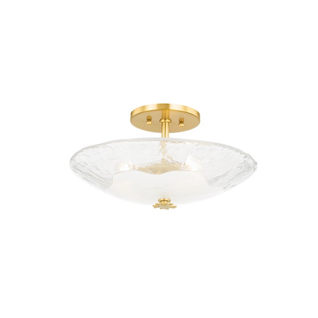 Glass takes center stage in this exquisite flush mount. The round shade is made of a thick piece of hand-blown piastra...