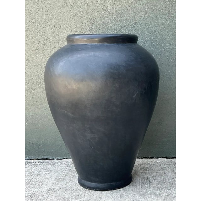 Crafted with monumental scale and a commanding presence, this vintage ceramic floor urn features an architectural baluster...