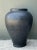 Crafted with monumental scale and a commanding presence, this vintage ceramic floor urn features an architectural baluster...