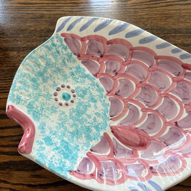 Whimsical vintage Italian ceramic serving platter crafted in the shape of a fish. Hand-painted in a playful palette of...