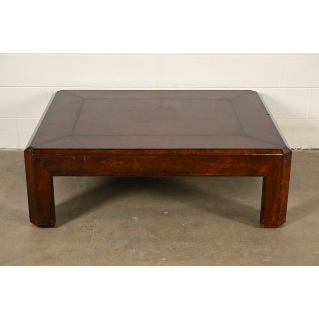 A gorgeous mid-century modern Hollywood Regency or Chinoiserie leather wrapped coffee table or cocktail table By Maitland...