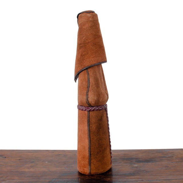 A vintage suede leather covered wine decanter in the form of a monk. 4 ¼ inches wide by 3 inches deep by 14 inches tall....