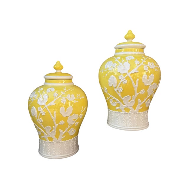 This exquisite pair of large Italian-made ceramic ginger jars in the Chinese style features molded relief prunus blossom...