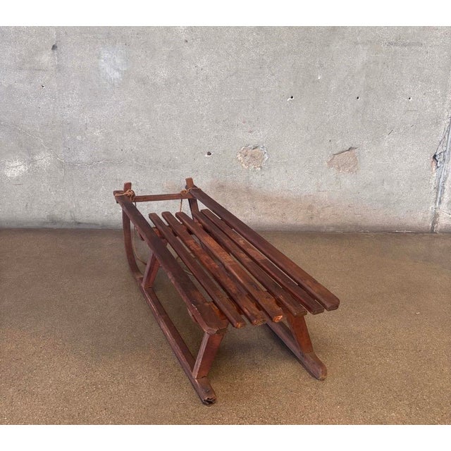 Vintage wooden pull sled featuring bent wood runners, a slatted seat and wonderfully aged original patina. Simple...