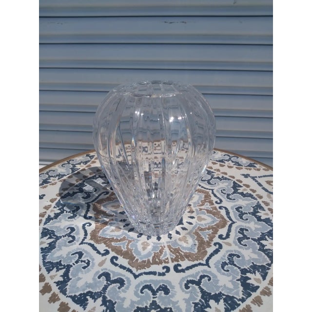 This vase is made out of heavy Crystal. It designed in a spherical shape and has etched designs . It makes for a great...