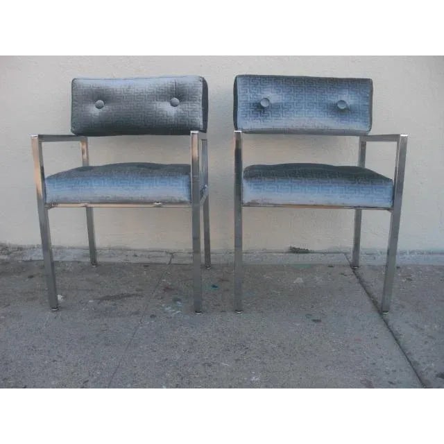 In the manner of Milo Baughman Founders chairs, this stylish and chic pair of modern armchairs with chromed-metal frames...