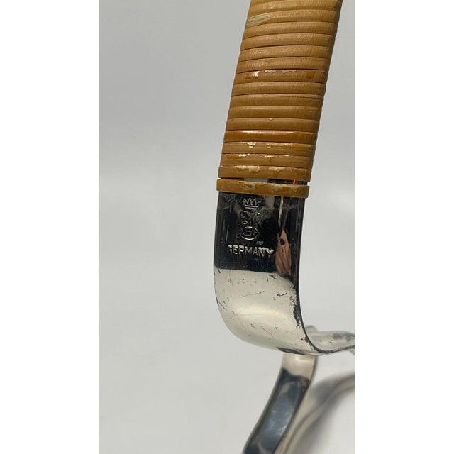 Mid century Eisenberg Lozano wine bottle holder in silver PLATED cane wrapped handle.