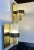 A pair of 1970s nautical - navy sconces composed of brass brackets set with cylindrical hand-blown tubes of rain-effect...