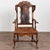 19th century Danish wingback armchair crafted of oak with vintage brown leather upholstery. The chair features a carved...