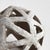 This contemporary little orb is made of thin ceramic strips giving it an open feel. It is perfect in a wide open bowl or...