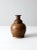 A mid-20th century studio pottery vase with a rounded body and narrow neck, accented by a carved swag detail circling the...