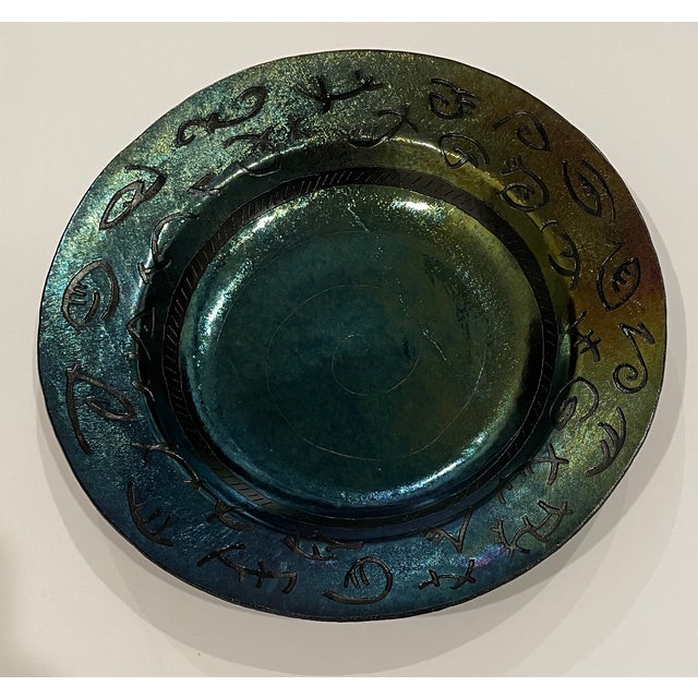 1994 charger or glass bowl by Massachusetts artist Lynn Latimer (born 1953). The art glass is iridescent with symbol...
