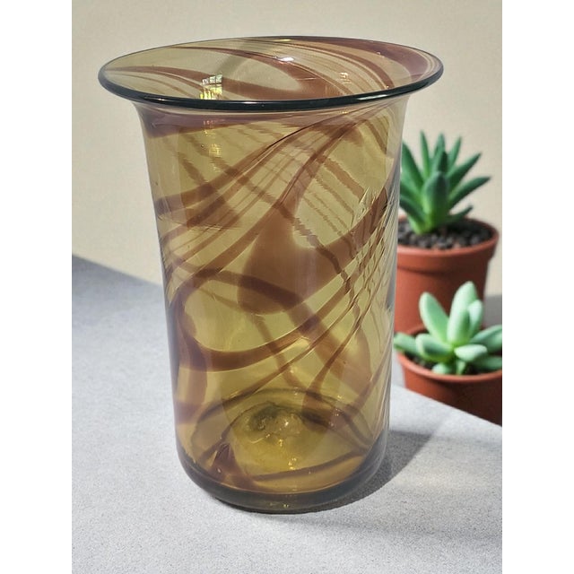 This Italian hand-blown art glass vase features a stunning amber chocolate brown swirl pattern, standing at 10'' high. The...