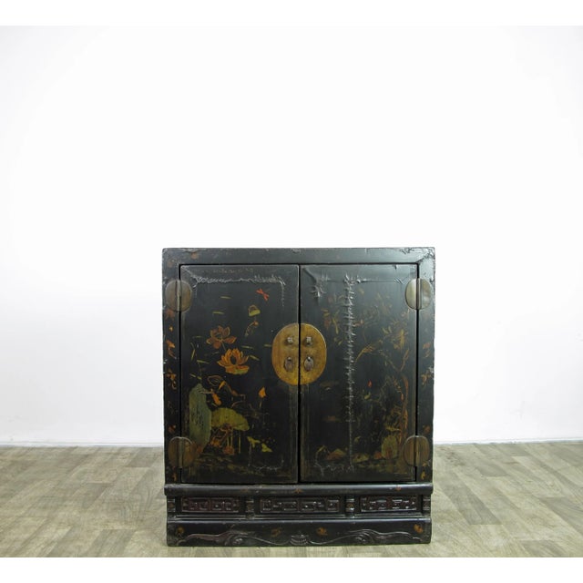 This mid 19 century antique cabinet has 2 panels door adorn with hand painted water lilies, flowers and birds. Beautiful...