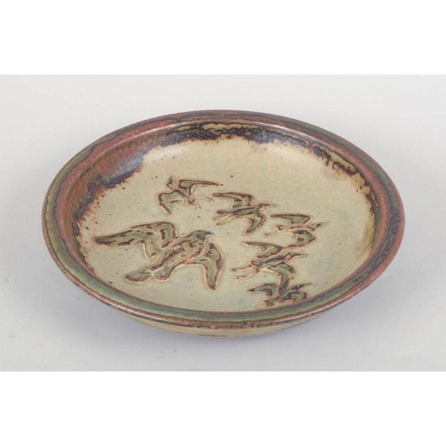Knud Kyhn for Royal Copenhagen, stoneware dish. Round stoneware dish, model 21586, decorated in relief with a stylised...